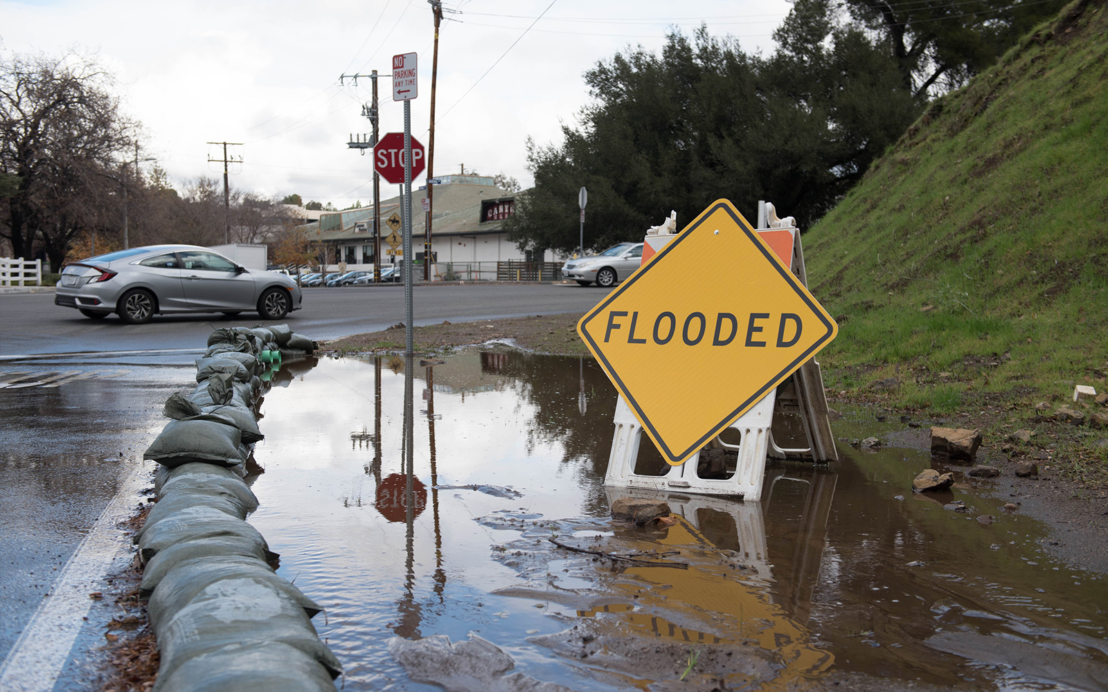 Photo of flooded area with a sign that says Flooded