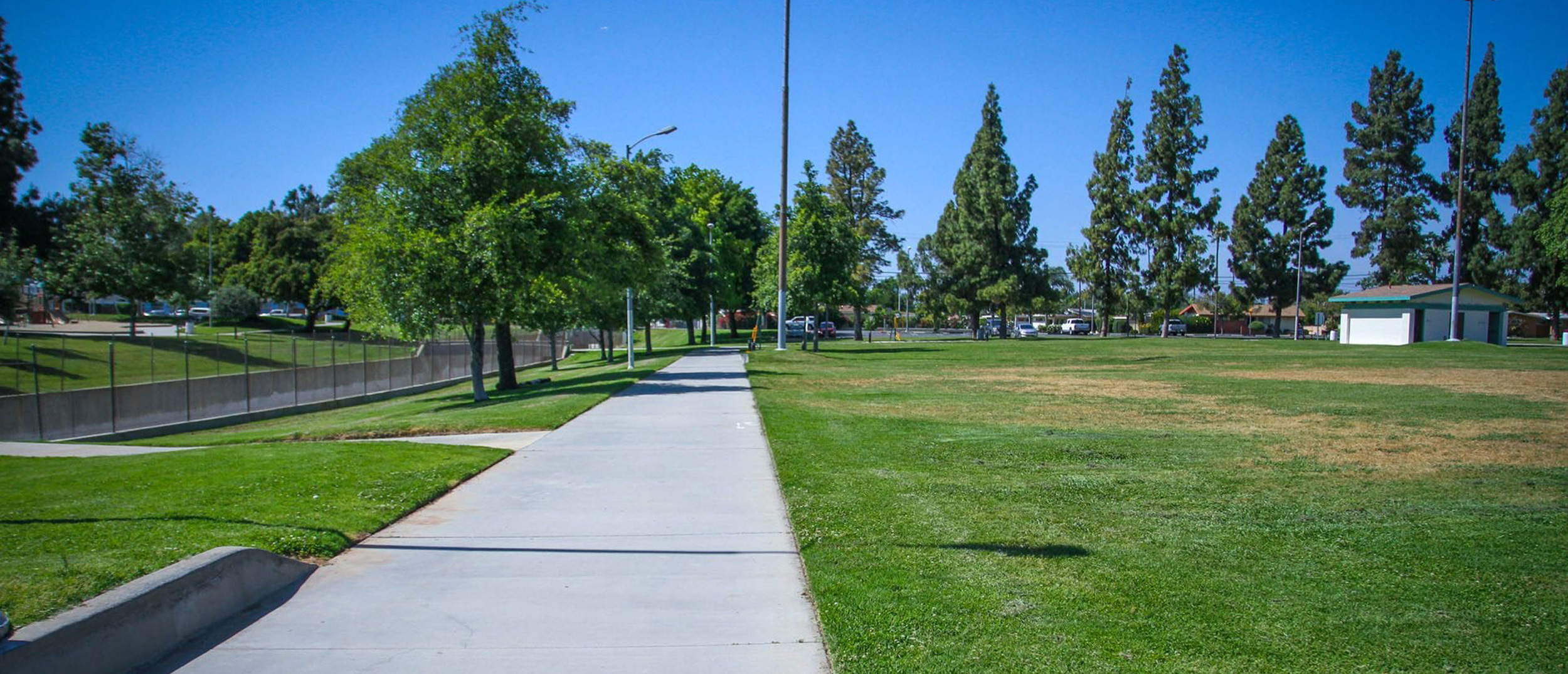 A wide view of the sprawling green fields and paved walking paths at Adventure Park, one of the region's Multi-benefit water projects designed for community recreation and underground stormwater capture.