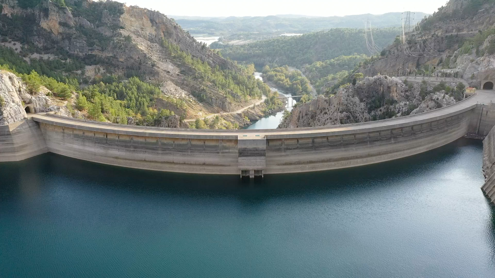 A panoramic view of a massive arch dam and blue reservoir, illustrating the large-scale infrastructure discussed in the LA County water FAQ for managing regional supply and stormwater capture.